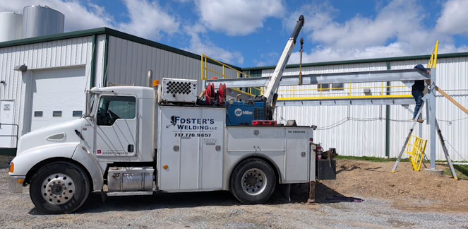 Foster's Welding LLCTruck crane holding ibeam in place while mezzanine is being built